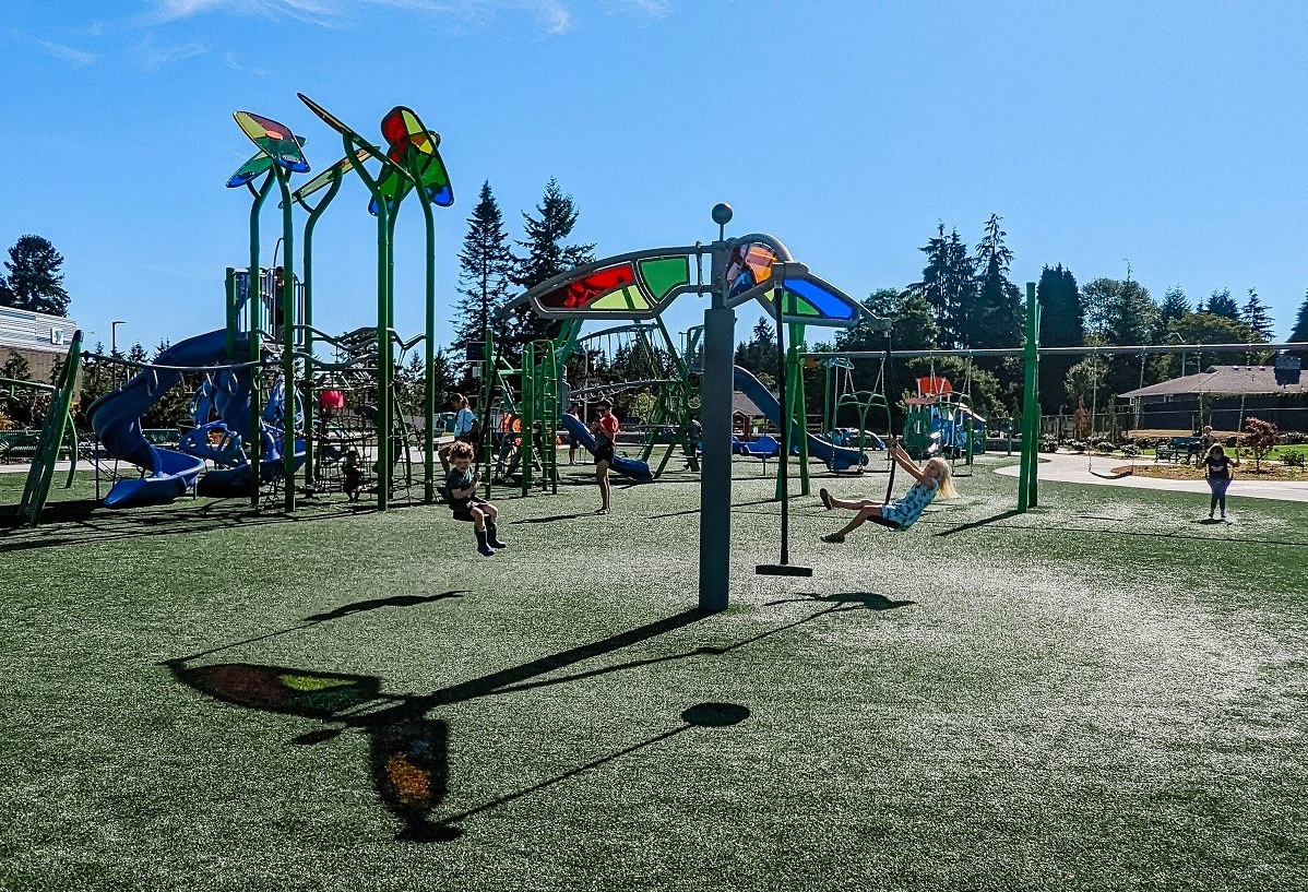 The popular tri runner group swing at Emma Yule Park’s new playground is like a fair ride and gets kids swinging into the air